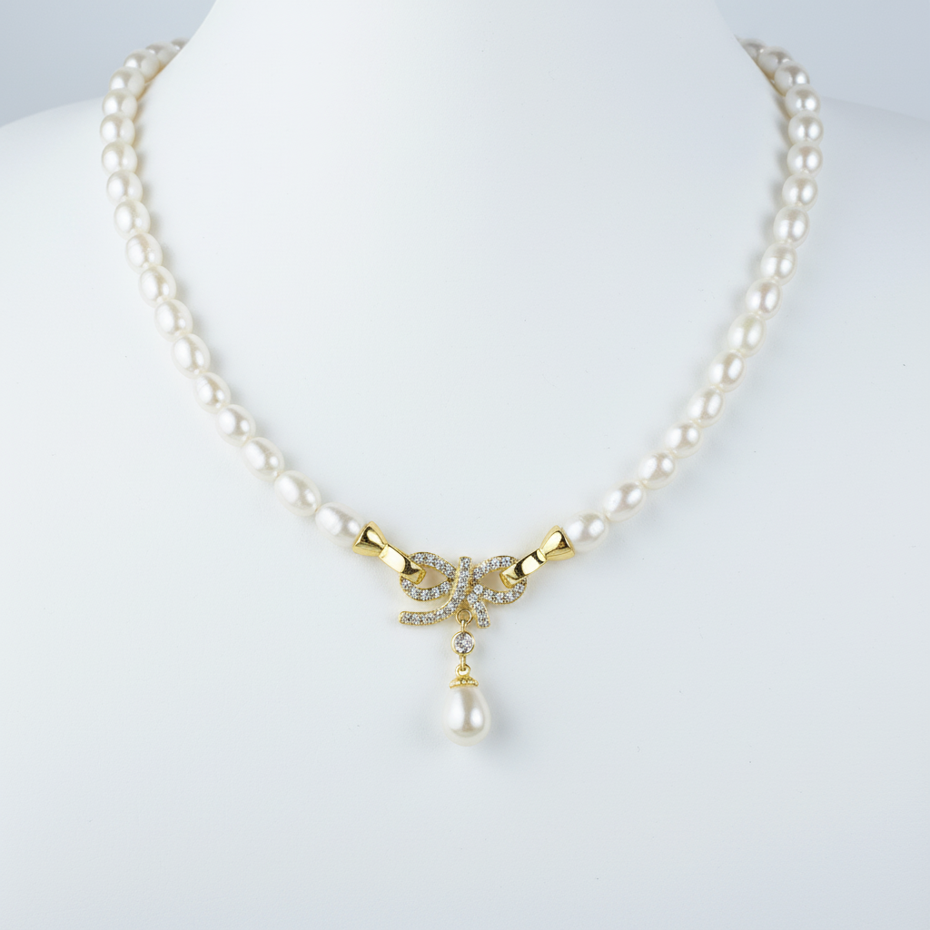 Chic Bridal Natural Smooth Rice Pearl Necklace with 18k Gold Plated Crystal Bow Pendant, Matching 18k Gold Plated earrings.Complete Bridal Set.